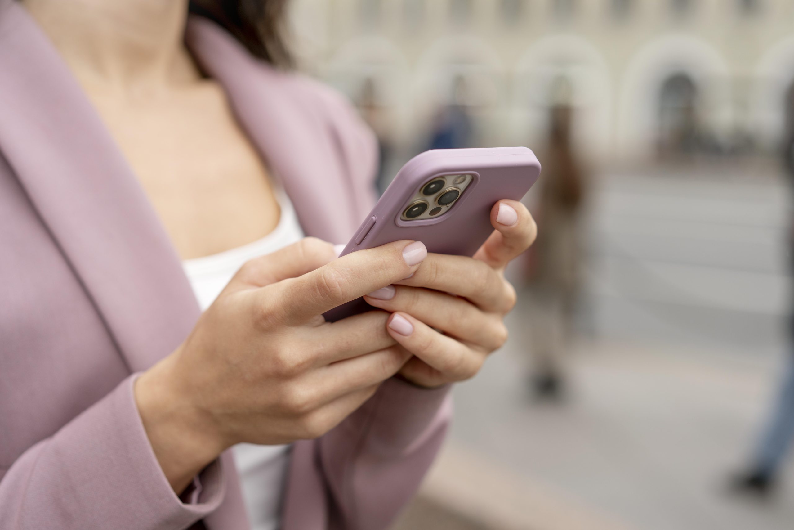 close up hands holding smartphone scaled